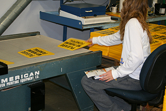 Worker collecting printed products