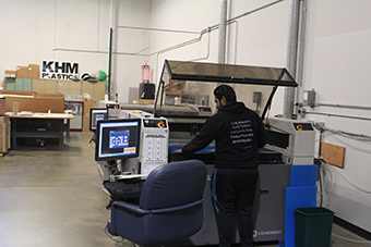 Man opperating a laser cutting machine