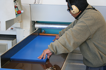 Worker operating a CNC router